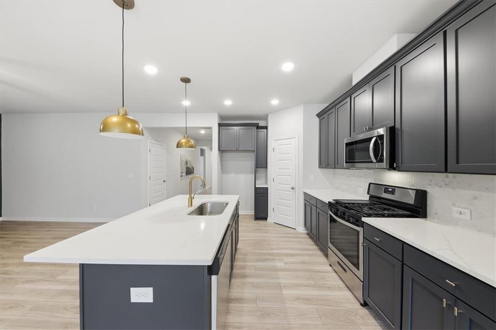 61 Rushing View Glen Dallas, GA 30157 - Photo 23 of 54 a kitchen with stainless steel appliances kitchen island granite countertop a sink a stove and refrigerator