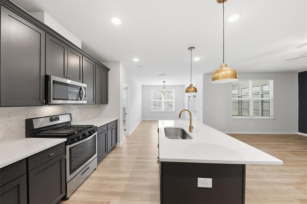 61 Rushing View Glen Dallas, GA 30157 - Photo 25 of 54 a kitchen with stainless steel appliances a sink a microwave a stove and refrigerator