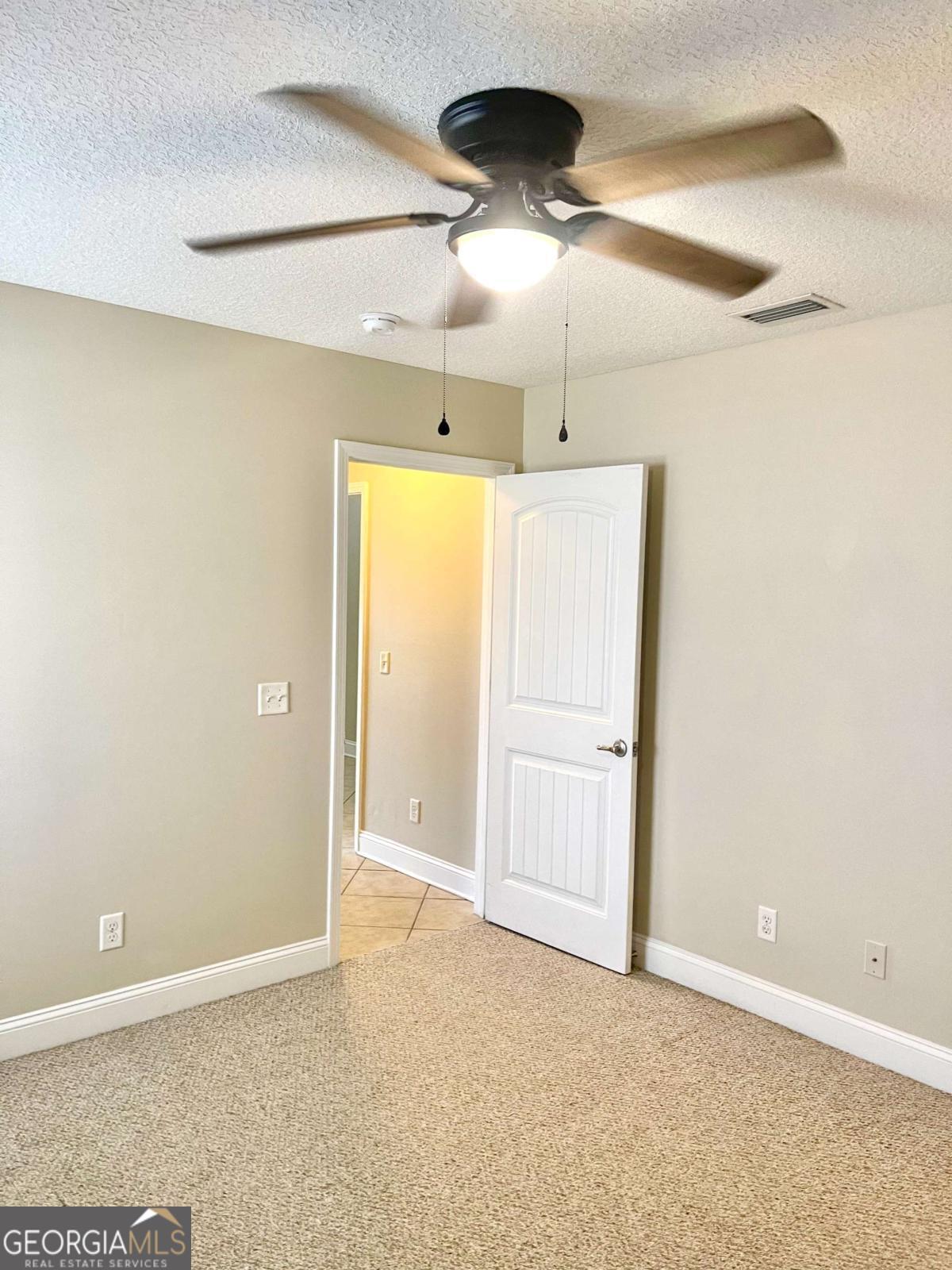 17 Fox Path St. Marys, GA 31558 - Photo 12 of 19 an empty room with a ceiling fan and a window