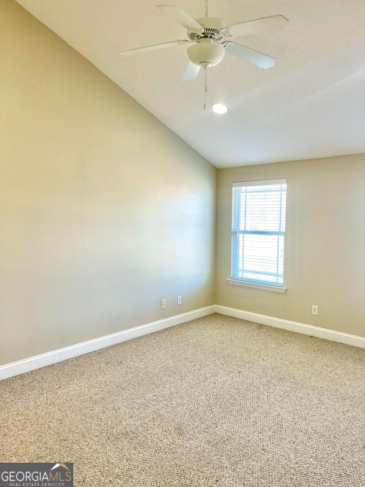17 Fox Path St. Marys, GA 31558 - Photo 13 of 19 an empty room with a chandelier fan and windows