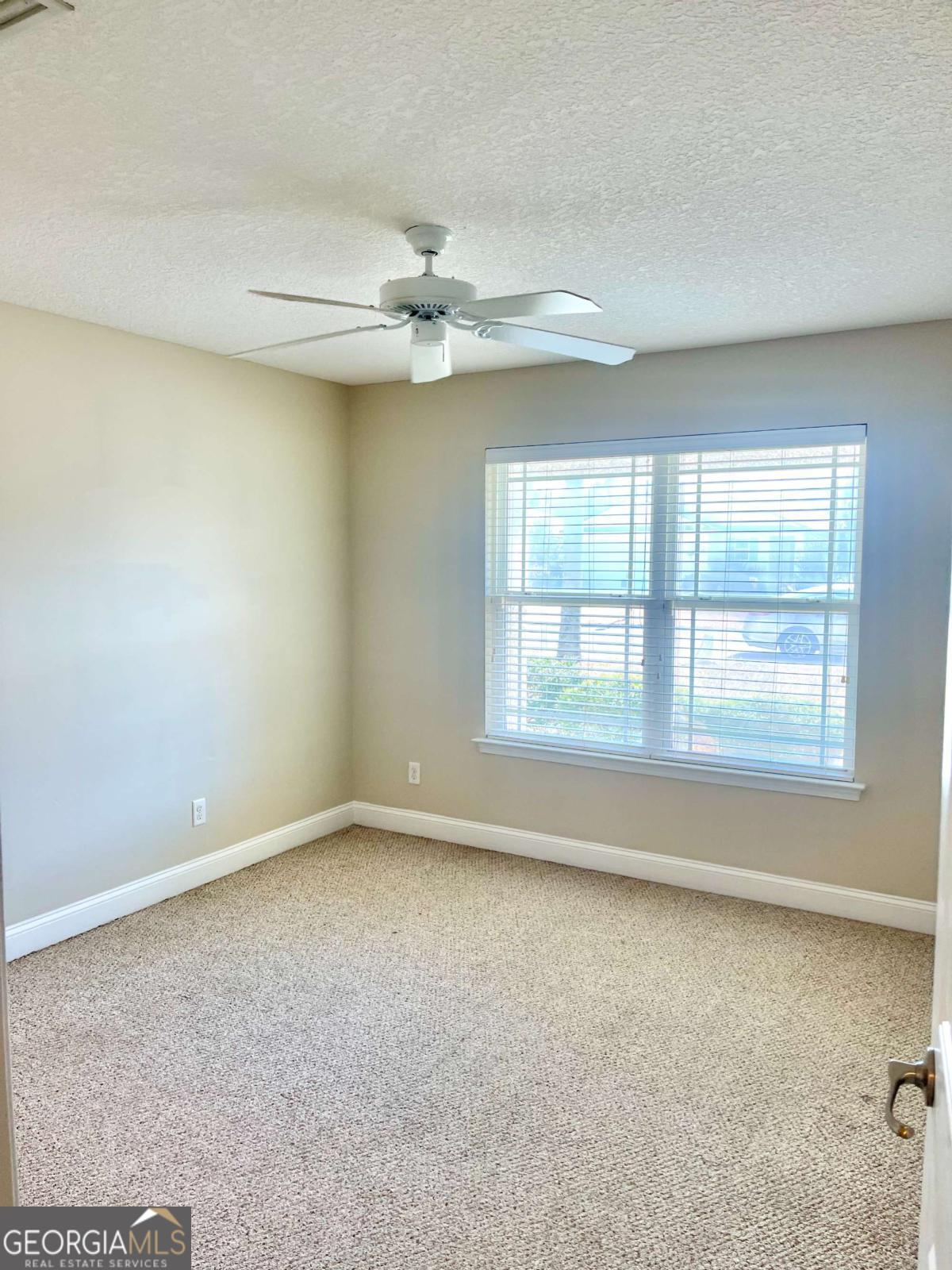 17 Fox Path St. Marys, GA 31558 - Photo 7 of 19 an empty room with a ceiling fan and window