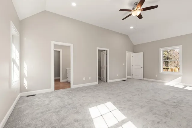 an empty room with windows and closet