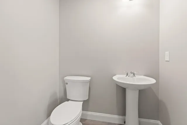 a bathroom with a sink a toilet and a mirror