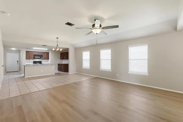 a kitchen with stainless steel appliances granite countertop a stove top oven a sink a counter top space and cabinets