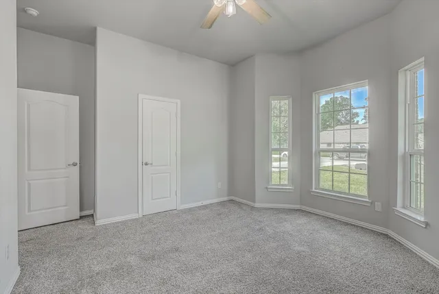 an empty room with windows and closet