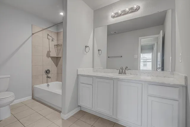 a bathroom with a toilet a sink and bathtub