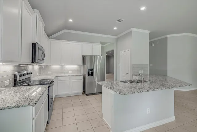 a kitchen with stainless steel appliances granite countertop a sink and stove