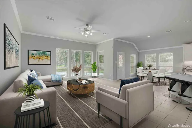 a view of a livingroom with furniture and a ceiling fan