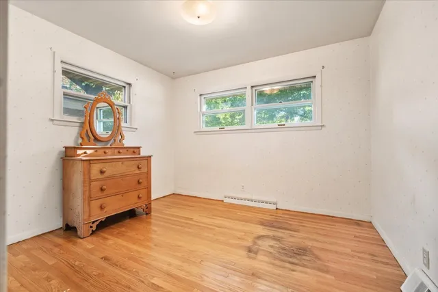 an empty room with windows and closet