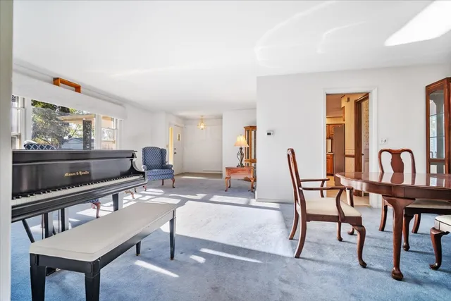 a dining room with furniture and window
