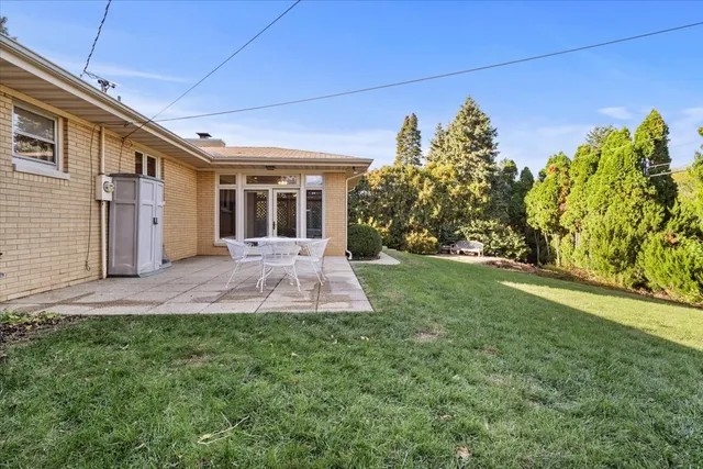 a view of a chairs and table in backyard of the house