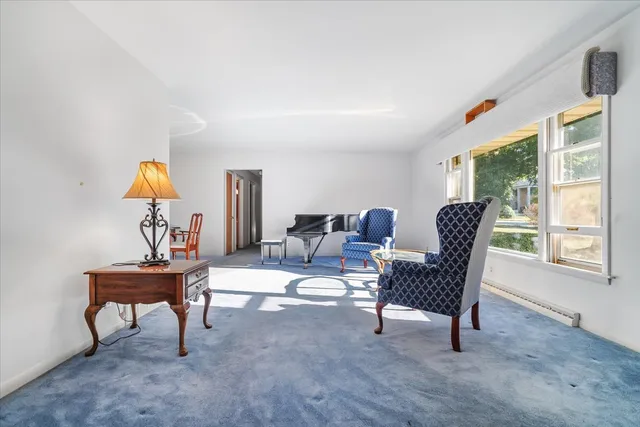 a living room with furniture a window and a flat screen tv