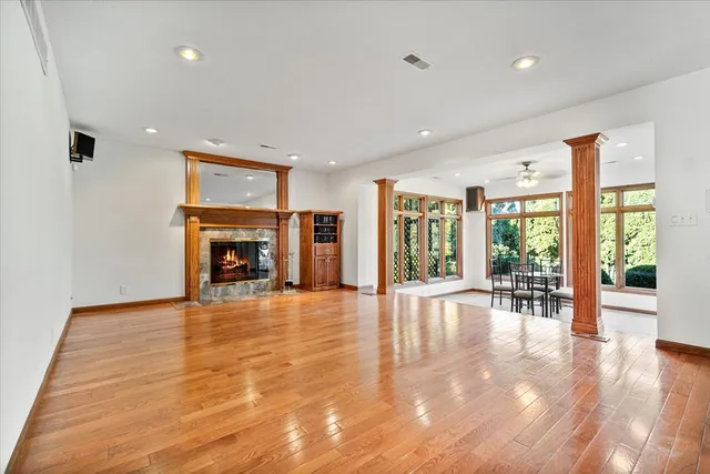 a view of empty room with fireplace and large window