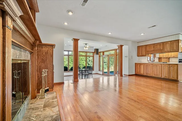a view of empty room with wooden floor and floor to ceiling window