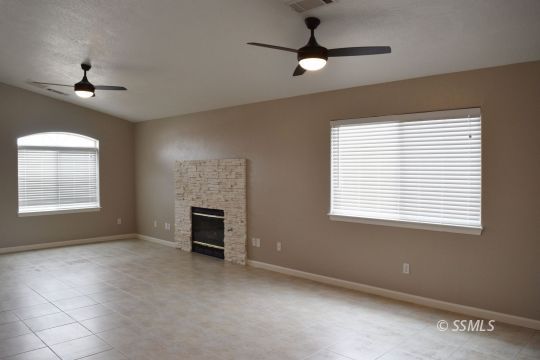 1405 Sims Street Ridgecrest, CA 93555 - Photo 3 of 12 a view of an empty room with a window and fireplace