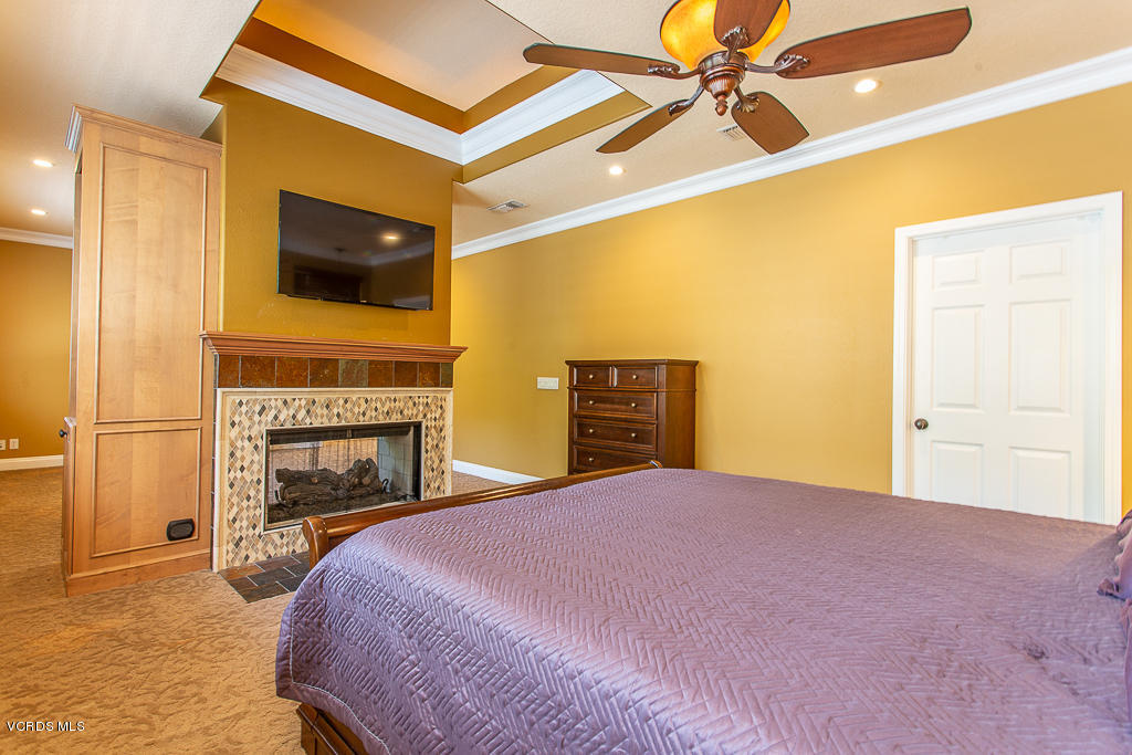 3821 Sunsetridge Road Moorpark, CA 93021 - Photo 22 of 49 a bedroom with a bed and a flat screen tv