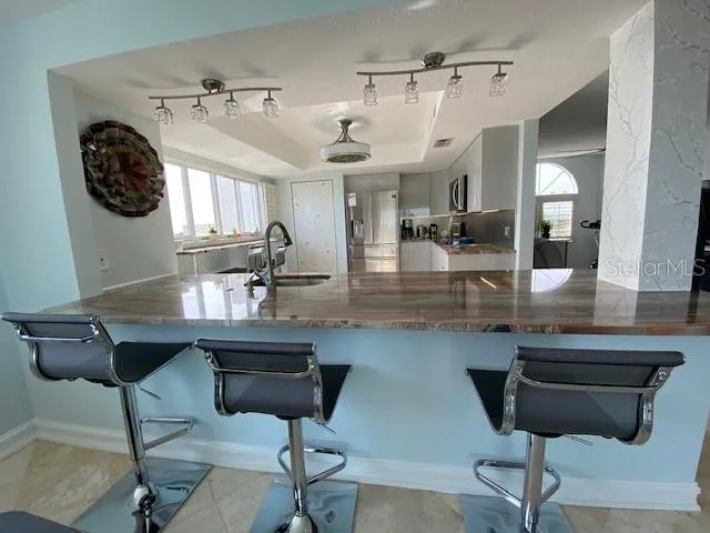 a view of a kitchen and dining area with chandelier
