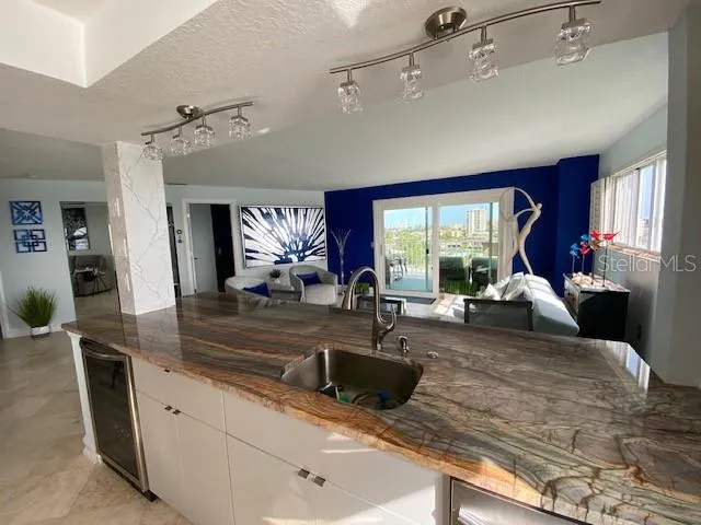a living room with furniture large window and flat screen tv