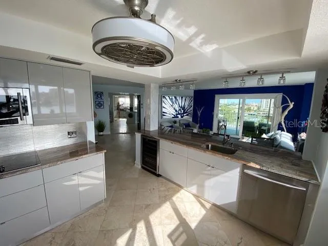 a large kitchen with stainless steel appliances kitchen island granite countertop a sink and cabinets
