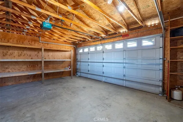 a view of a room with wooden floor and iron stairs