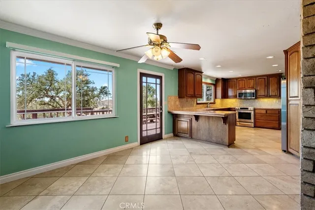 a large kitchen with stainless steel appliances granite countertop a stove top oven a sink dishwasher and a refrigerator