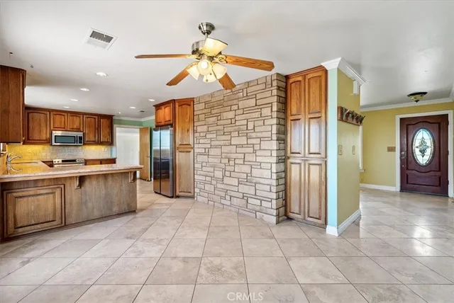 a kitchen with stainless steel appliances granite countertop a refrigerator and a sink