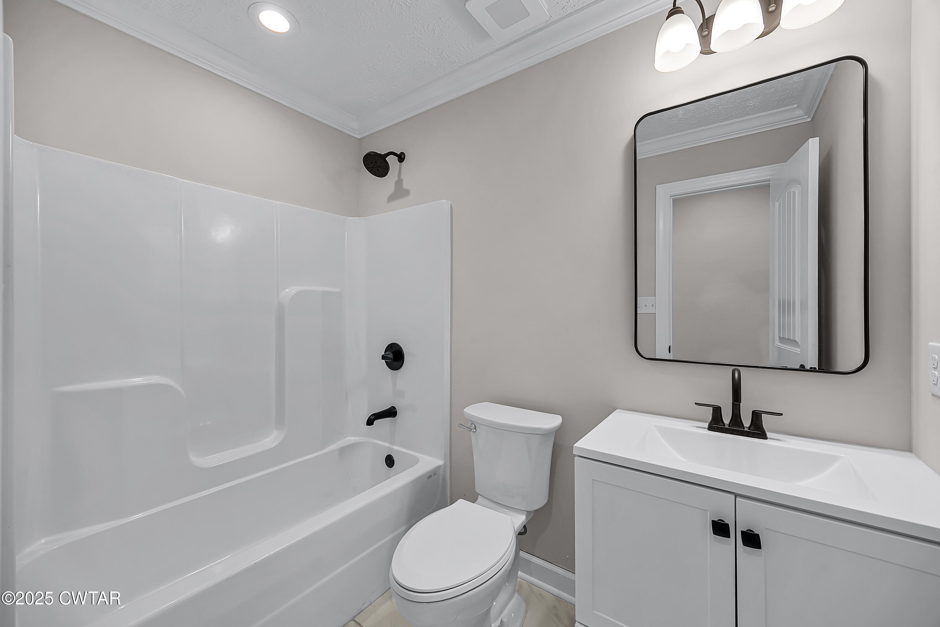 757 Christi Loop Henderson, TN 38340 - Photo 16 of 21 a bathroom with a toilet a sink a mirror a bathtub and vanity