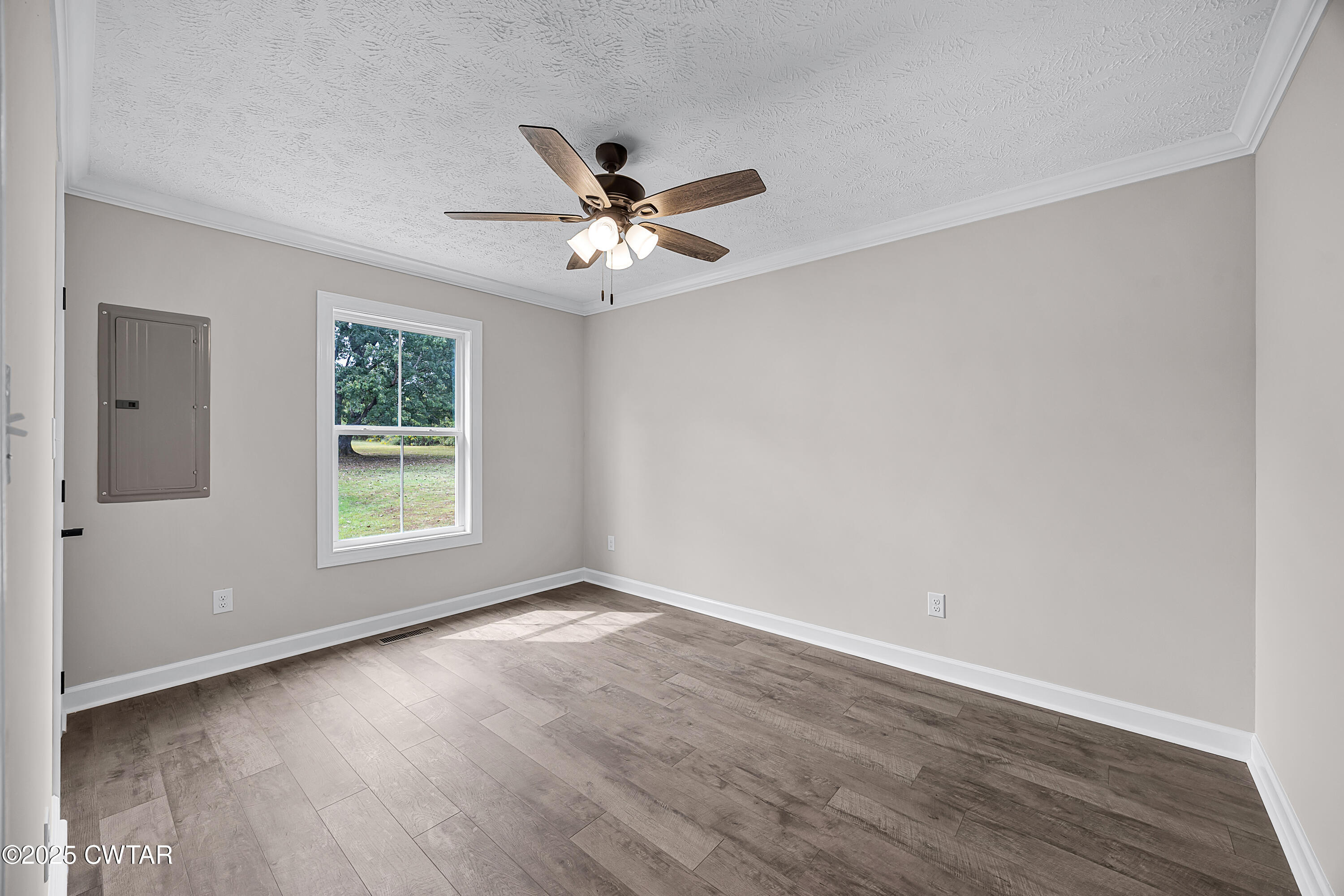 757 Christi Loop Henderson, TN 38340 - Photo 17 of 21 an empty room with wooden floor fan and windows