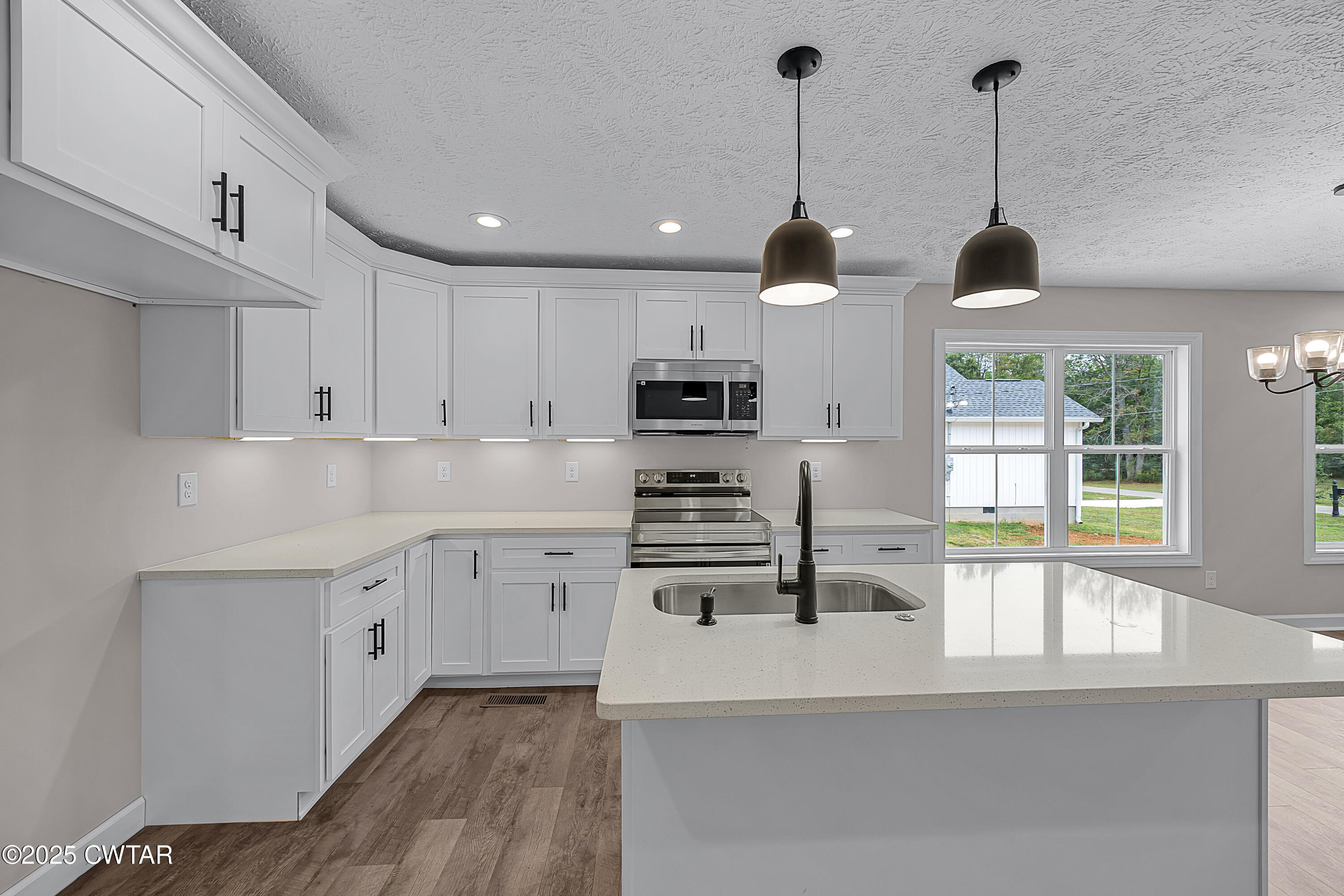 757 Christi Loop Henderson, TN 38340 - Photo 2 of 21 a kitchen with stainless steel appliances granite countertop a stove a sink and a wooden floors