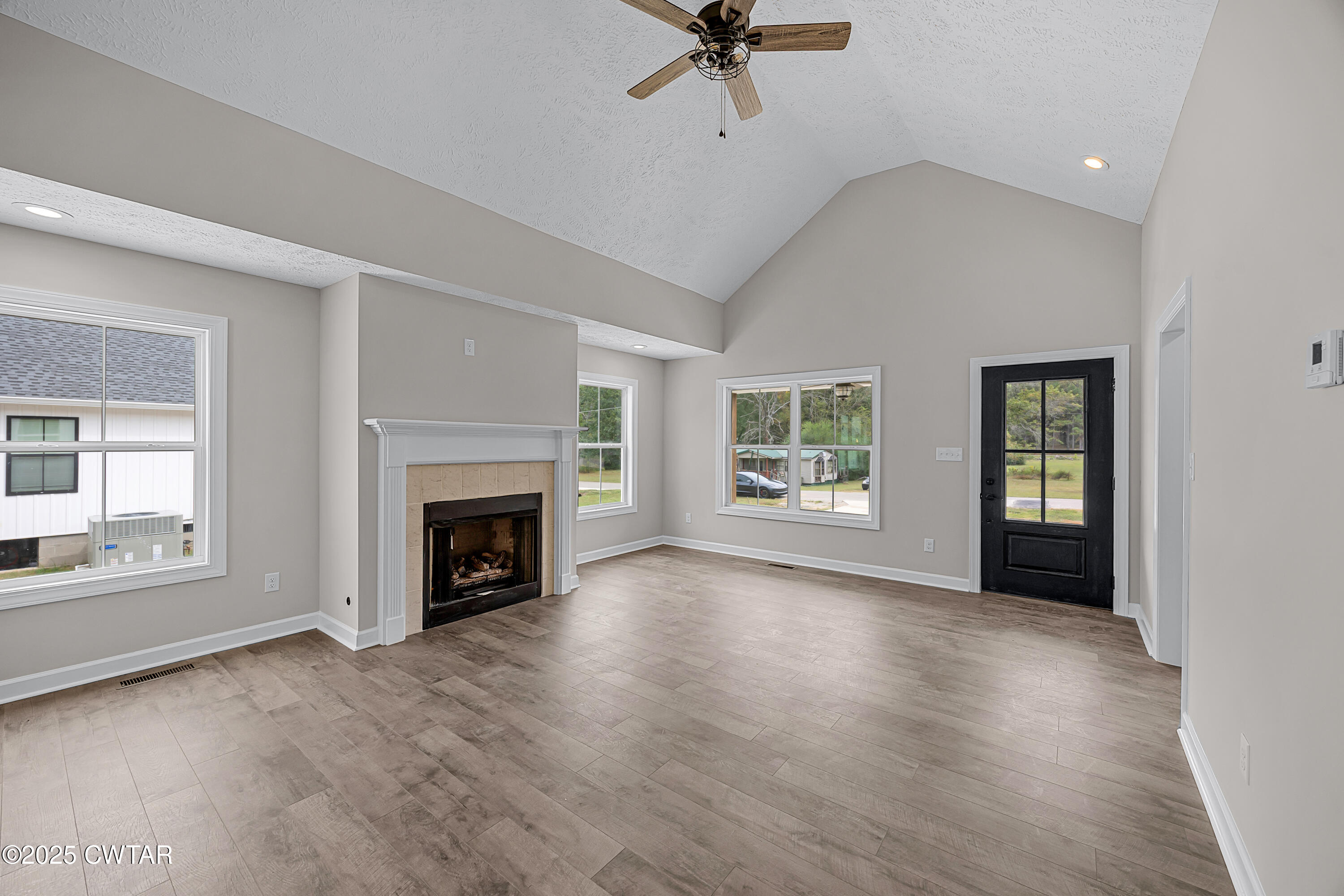 757 Christi Loop Henderson, TN 38340 - Photo 7 of 21 wooden floor fireplace and windows in an empty room