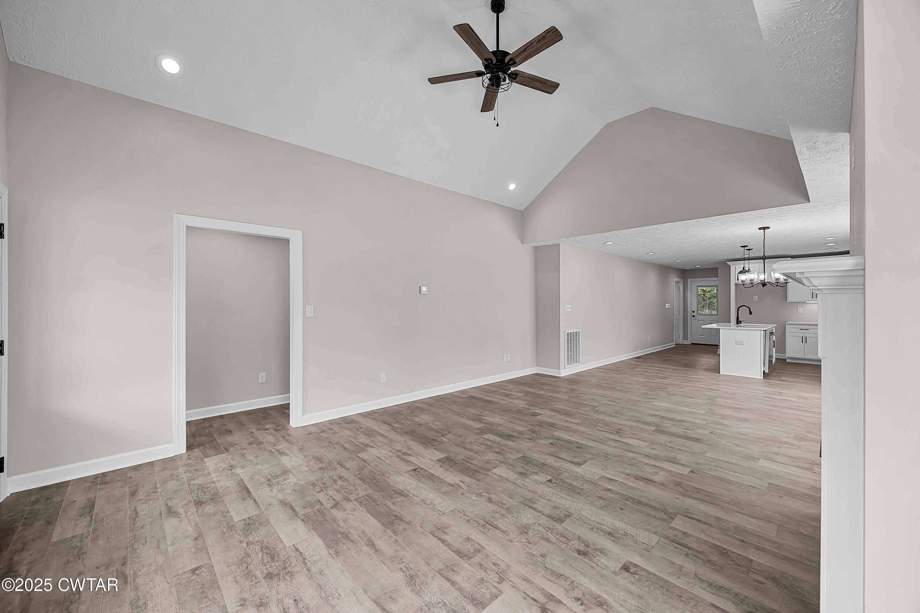 757 Christi Loop Henderson, TN 38340 - Photo 9 of 21 a view of a livingroom with a ceiling fan & kitchen floor