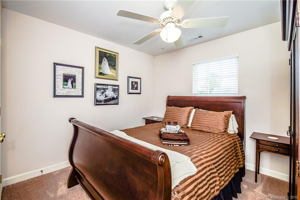 15739 Trenton Place Road Huntersville, NC 28078 - Photo 9 of 16 a bedroom with a bed and a chandelier