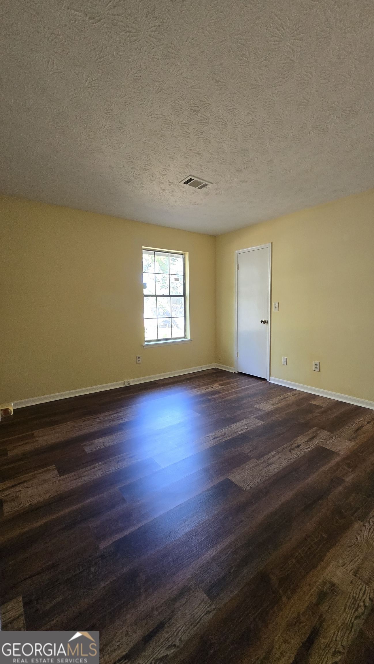 2416 Newgate Drive Decatur, GA 30035 - Photo 15 of 16 an empty room with wooden floor and windows