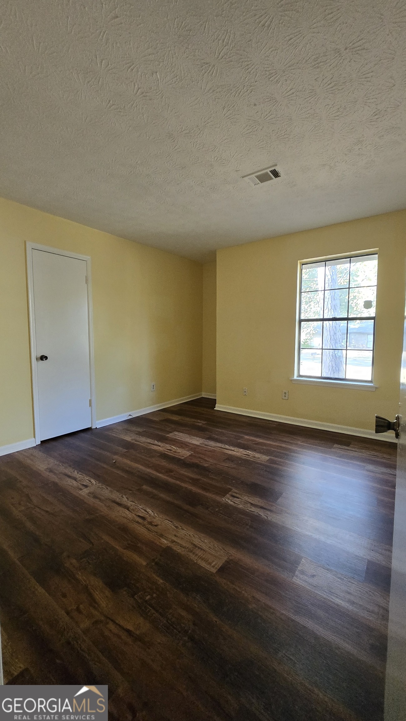 2416 Newgate Drive Decatur, GA 30035 - Photo 16 of 16 an empty room with wooden floor and windows