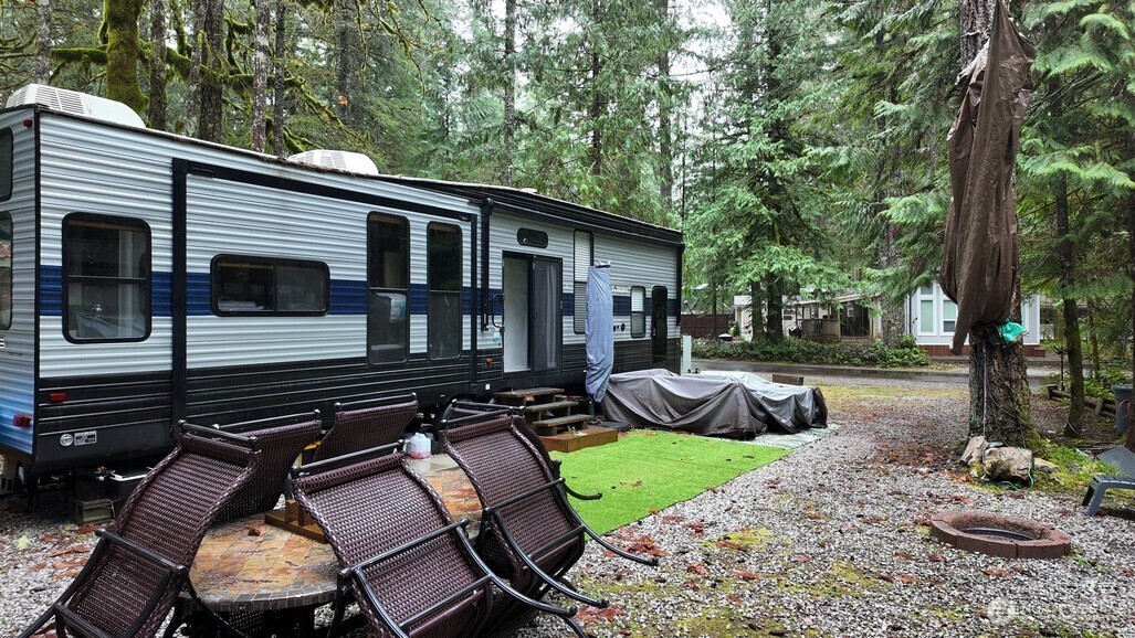 134 Jasper Trail Deming, WA 98244 - Photo 12 of 20 a view of a patio with chair and tables back yard of the house