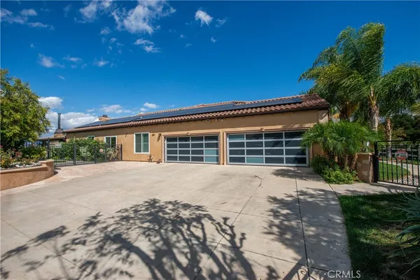 a front view of a house with a garden and yard