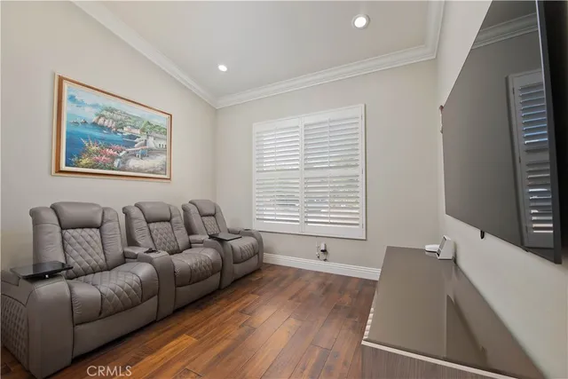 a kitchen with granite countertop a stove a dining table and chairs with wooden floor