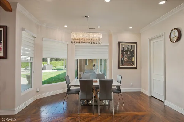 a kitchen with stainless steel appliances kitchen island granite countertop a table and chairs in it