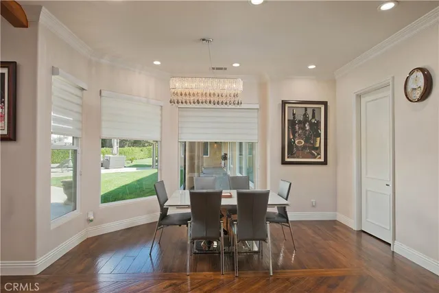 a kitchen with stainless steel appliances kitchen island granite countertop a table and chairs in it