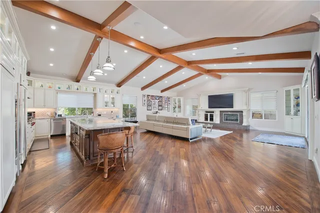 a kitchen with stainless steel appliances granite countertop a refrigerator and a stove
