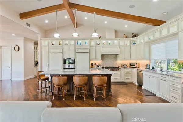 a living room with furniture and a book shelf