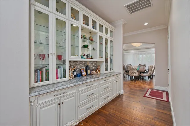 a bedroom with a large bed and wooden floor