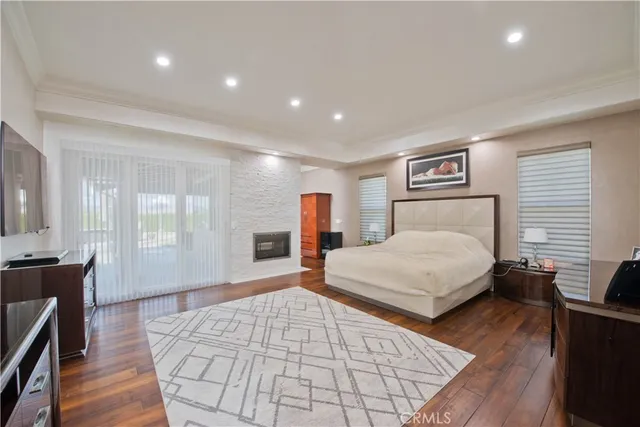 a spacious bathroom with a granite countertop sink a mirror and a bathtub