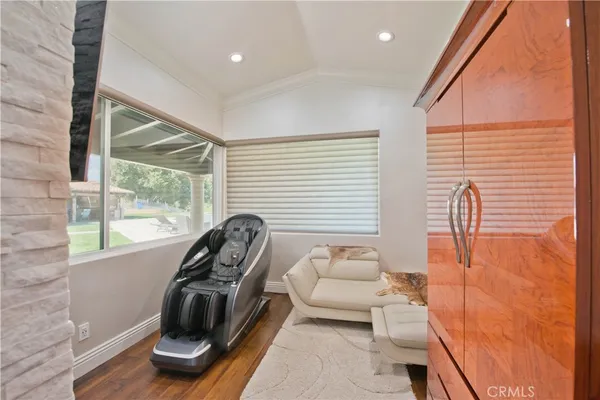 a dining room with furniture and wooden floor