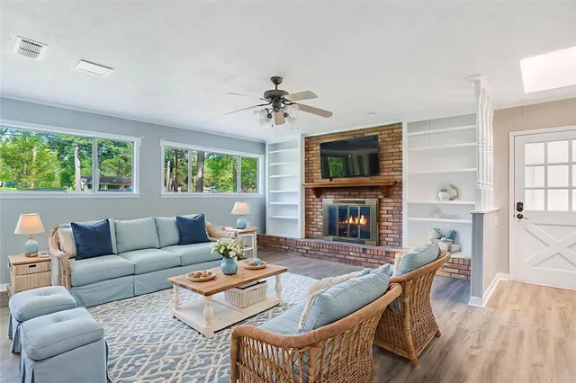 a living room with furniture fireplace and a flat screen tv