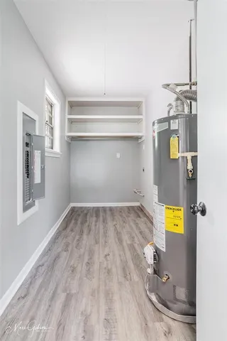 a view of empty room with wooden floor and wall painting