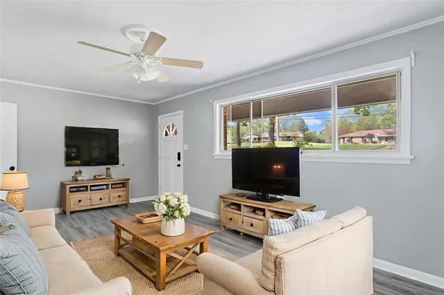 a living room with furniture and a flat screen tv
