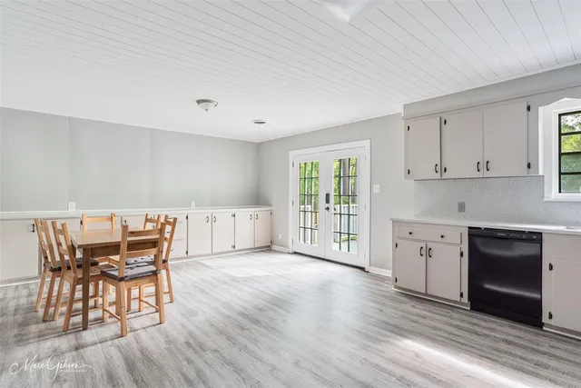 a view of a kitchen with wooden floor and a sink