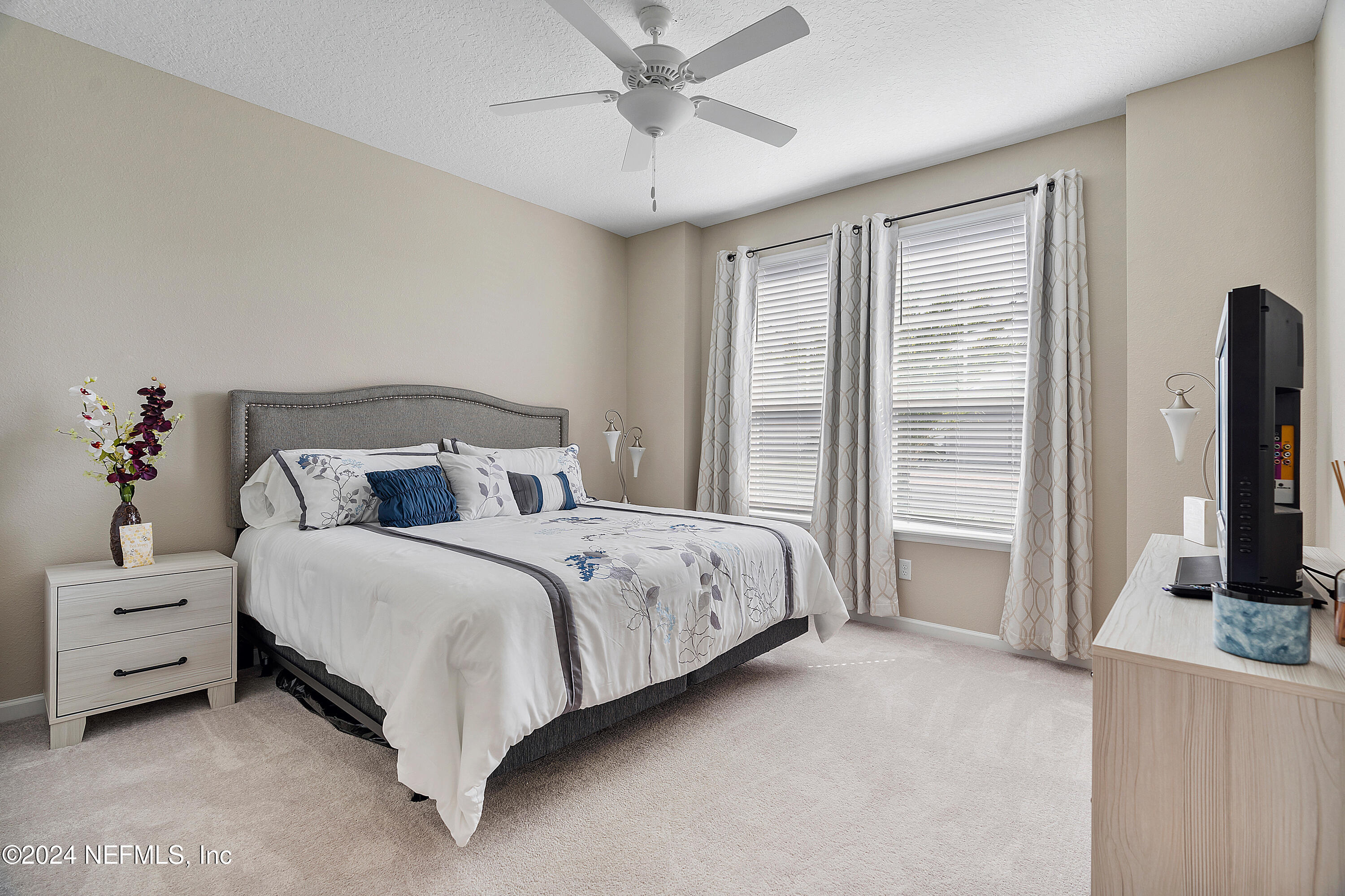 208 Gan Way St. Johns, FL 32259 - Photo 3 of 53 a spacious bedroom with a bed and a flat tv screen on dresser