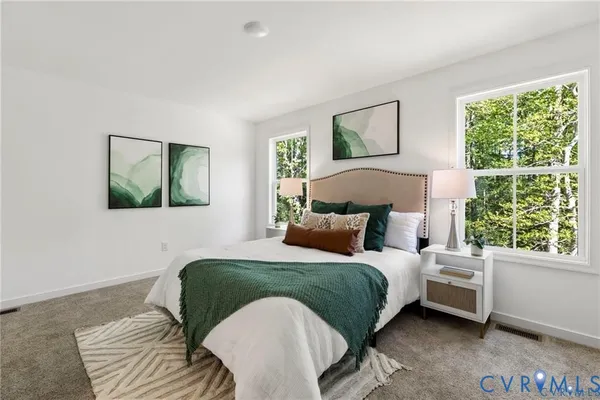 a bedroom with a bed wooden floor and window